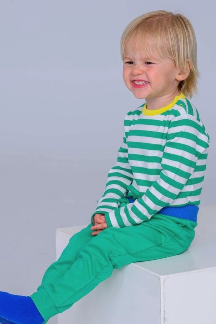 Toddler wearing organic baby joggers by Dew and Dove