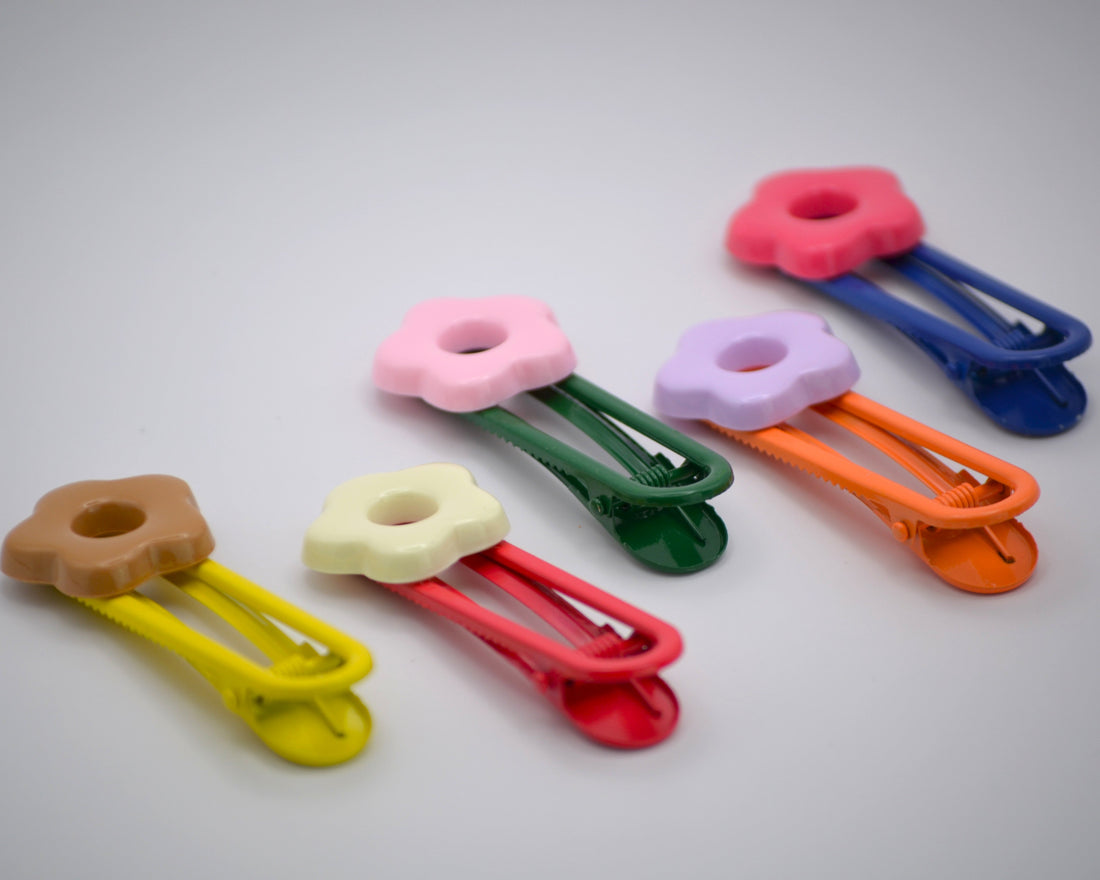 Baby girl wearing colorful hair clips by Dew and Dove