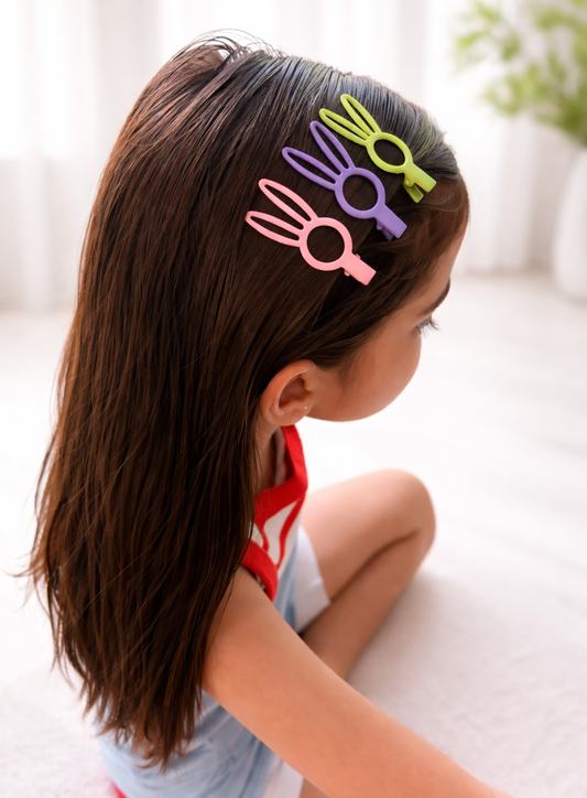 Girl with colorful bunny-shaped hair clips in her hair