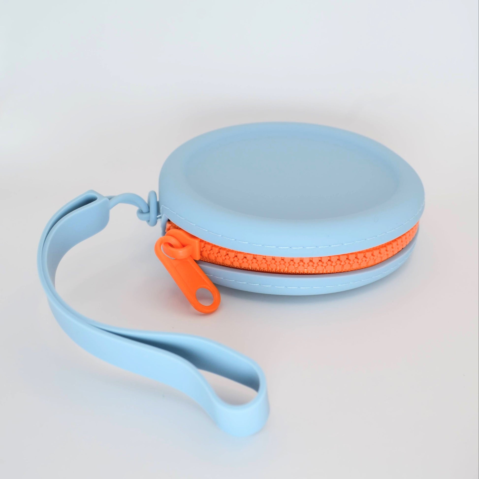Light blue pouch with an orange zipper on a light gray background
