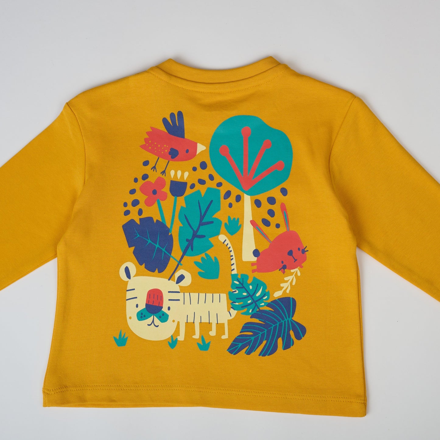 Yellow long-sleeve shirt with colorful animal and plant design on a white background