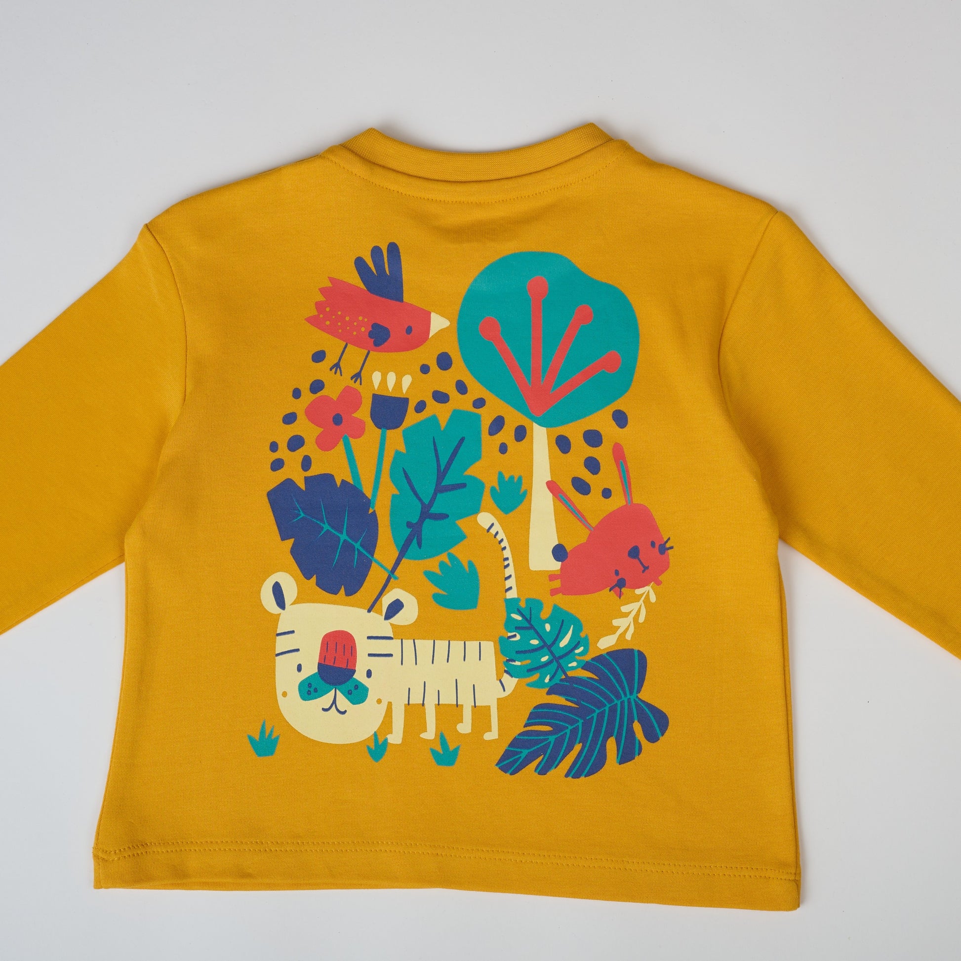 Yellow long-sleeve shirt with colorful animal and plant design on a white background