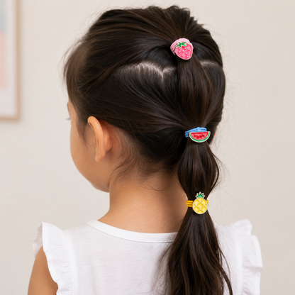 Child with ponytail using colorful hair accessories against a plain background