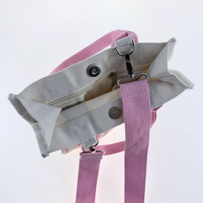 Interior of Dew & Dove cotton canvas tote bag with pink straps, zip pocket and magnetic closure