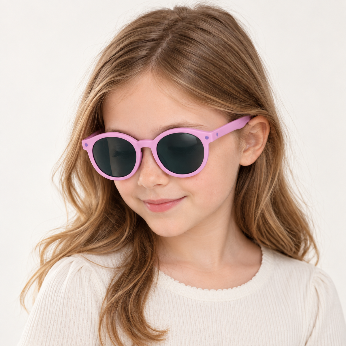 Kid wearing pink and purple round sunglasses