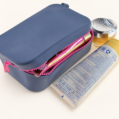 Dew & Dove Color Pop Silicone Zip Pouch in Midnight Pop with bright pink zipper, open with essentials